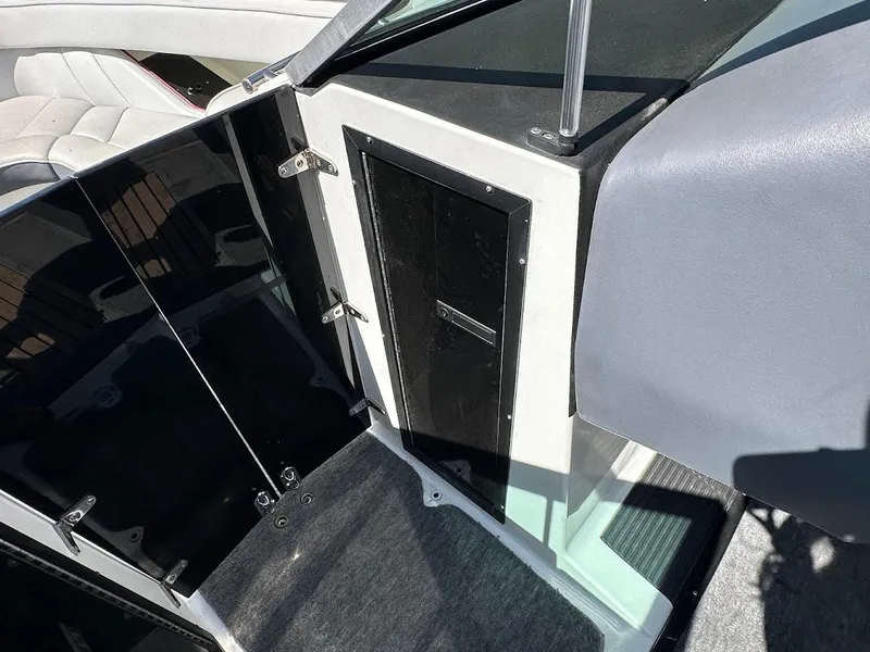 Slide: The Image of Interior view of a 1991 Cobalt Condurre 222 boat, featuring seating and cabin entrance. - 36