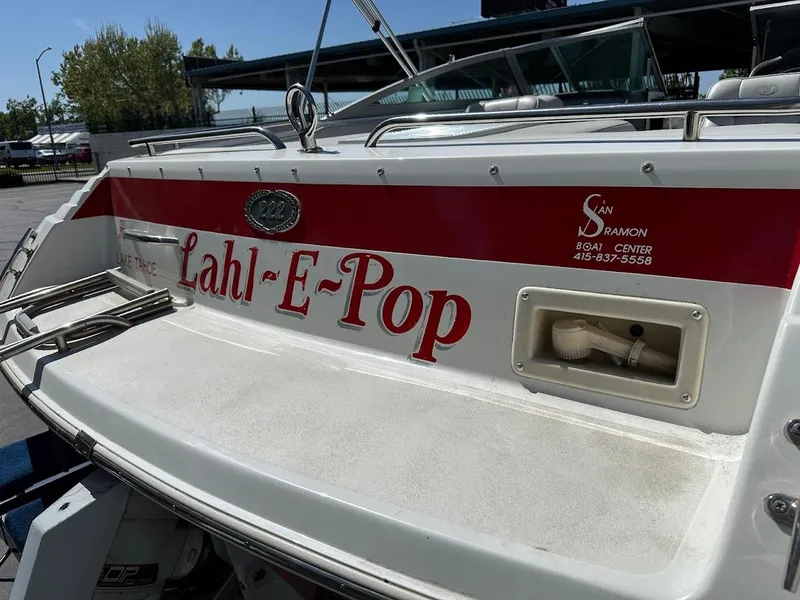 Slide: The Image of 1991 Cobalt Condurre 222 boat with "Lahl-E-Pop" name on the stern, docked outdoors. - 37
