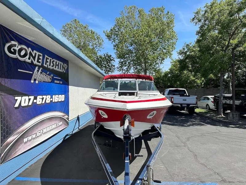 Slide: The Image of Red and white 1991 Cobalt Condurre 222 boat on trailer, parked near a building. - 4