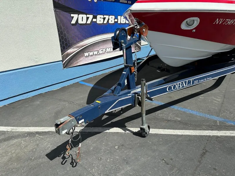 Slide: The Image of 1991 Cobalt Condurre 222 boat on trailer, parked in a lot. - 5