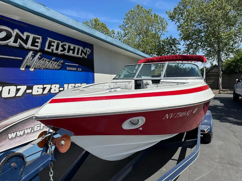 Slide: The Image of 1991 Cobalt Condurre 222 boat on trailer, red and white design, parked outdoors. - 6