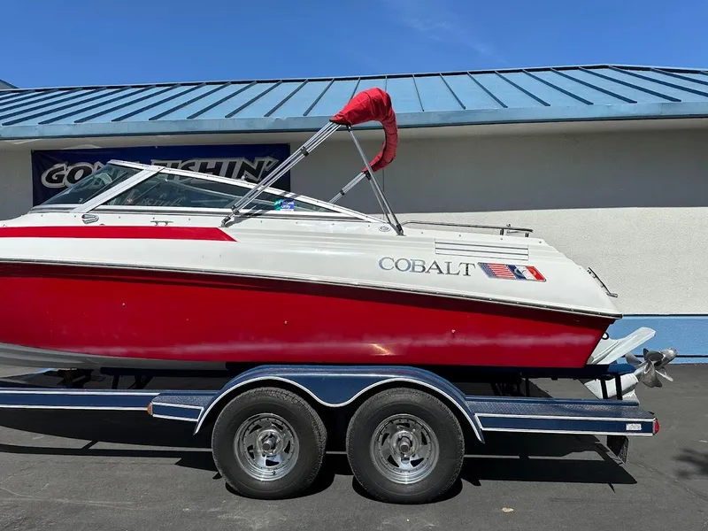 Slide: The Image of Red and white 1991 Cobalt Condurre 222 boat on trailer, parked outdoors. - 8