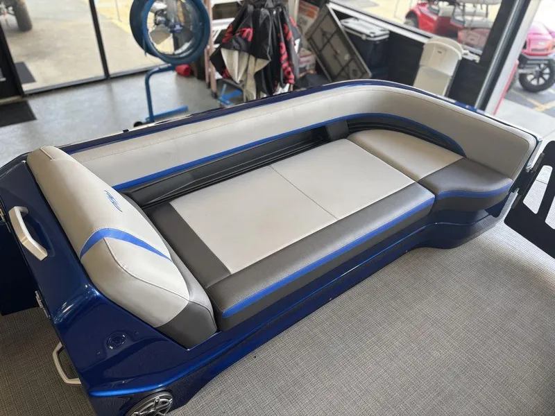 Slide: The Image of 2024 Manitou 25 XT SRS SHP boat seating, blue and gray upholstery, showroom display. - 10