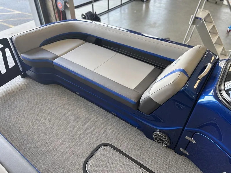 Slide: The Image of 2024 Manitou 25 XT SRS SHP boat interior with sleek seating and modern design. - 11