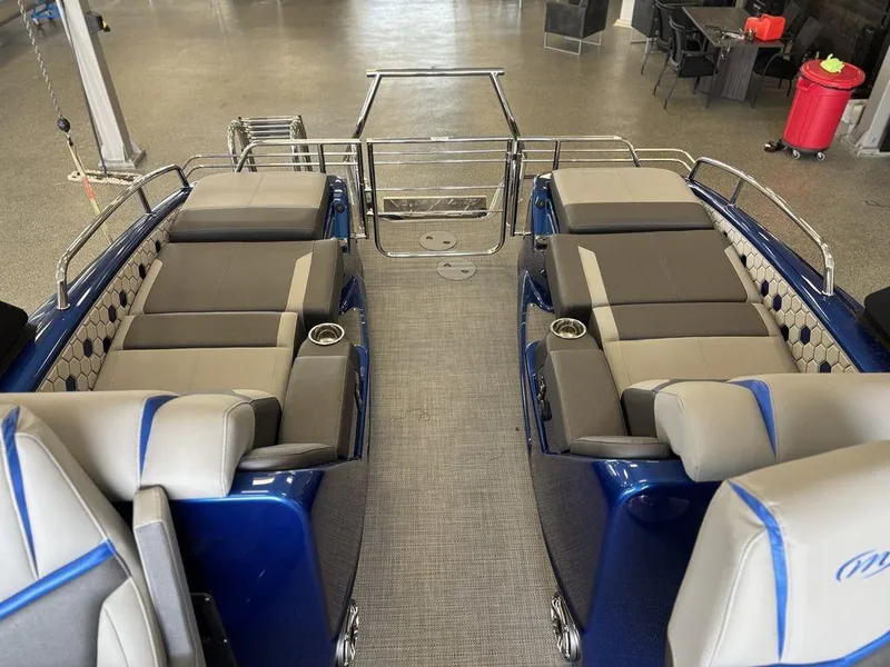Slide: The Image of 2024 Manitou 25 XT SRS SHP pontoon boat interior with luxurious seating and cup holders. - 18