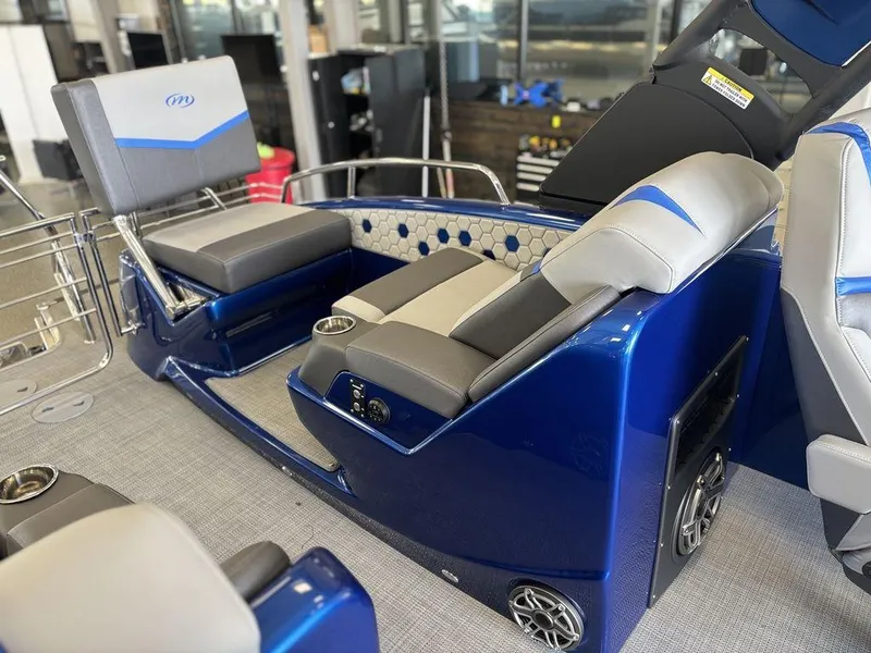 Slide: The Image of 2024 Manitou 25 XT SRS SHP boat interior with blue and gray seating. - 19