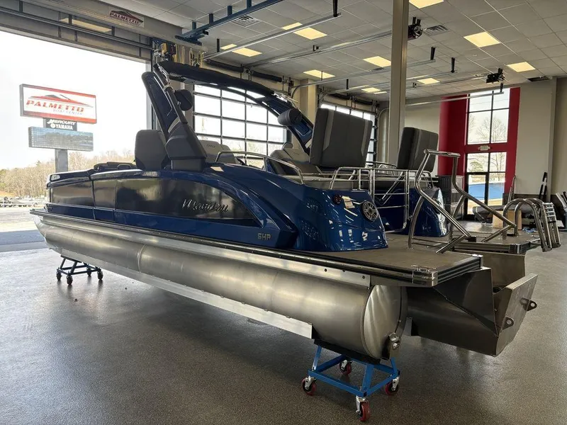 Slide: The Image of 2024 Manitou 25 XT SRS SHP pontoon boat in showroom, side view. - 4