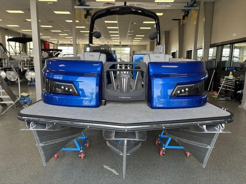 Slide: The Image of 2024 Manitou 25 XT SRS SHP pontoon boat in showroom, front view. - 7