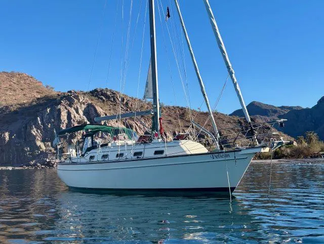 Slide: The Image of 2008 Island Packet 370 sailboat anchored in scenic coastal waters. - 0