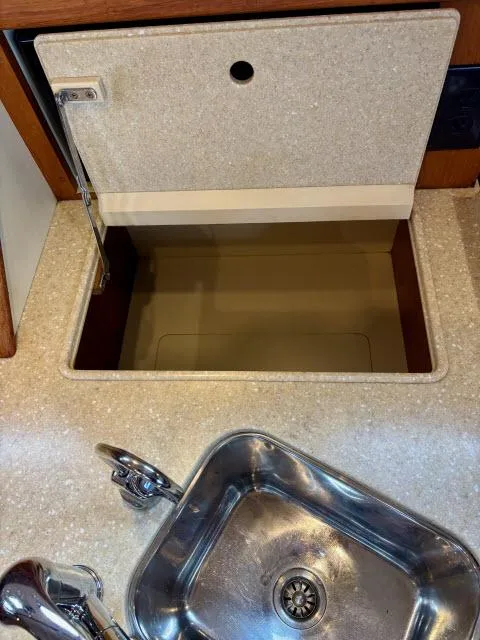 Slide: The Image of 2008 Island Packet 370 yacht kitchen sink and storage compartment. - 10