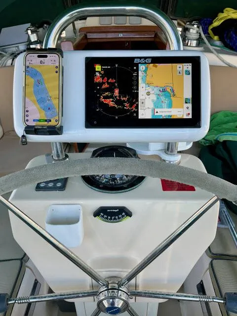 Slide: The Image of Steering console of a 2008 Island Packet 370 sailboat with navigation displays. - 21