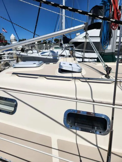 Slide: The Image of 2008 Island Packet 370 sailboat deck with hatches and rigging in marina. - 22
