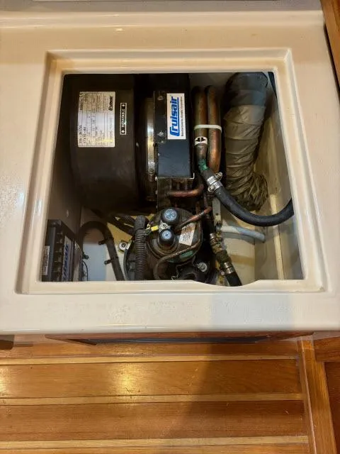 Slide: The Image of Engine compartment of 2008 Island Packet 370 sailboat, featuring a Fischer Panda generator. - 34