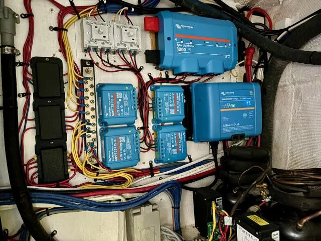 Slide: The Image of Electrical system of a 2008 Island Packet 370 sailboat, featuring wiring and blue control units. - 35