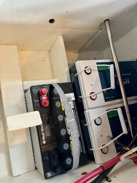 Slide: The Image of Battery compartment of a 2008 Island Packet 370 sailboat, featuring multiple batteries. - 36