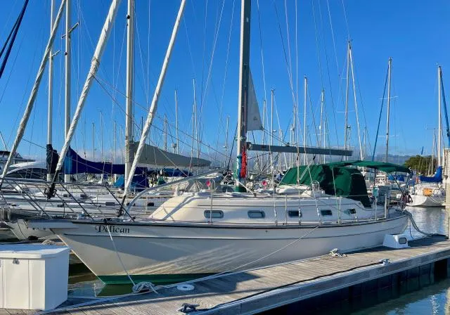 Slide: The Image of 2008 Island Packet 370 sailboat docked in a marina, surrounded by other boats. - 38