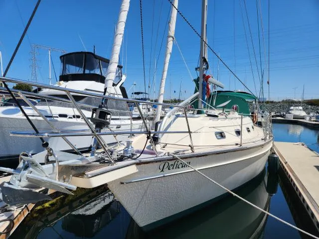 Slide: The Image of 2008 Island Packet 370 sailboat docked in marina under clear blue sky. - 39