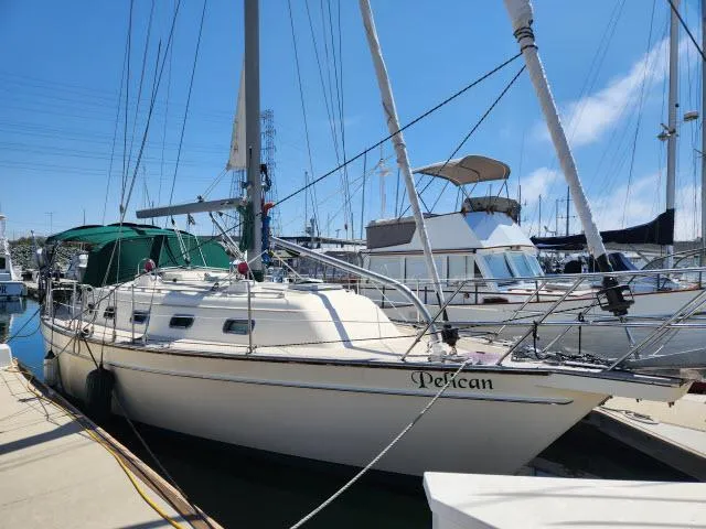 Slide: The Image of 2008 Island Packet 370 sailboat docked at marina under clear blue sky. - 41
