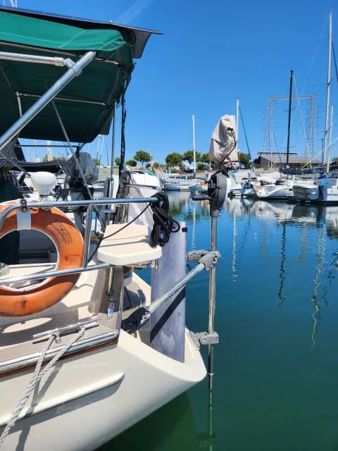 Slide: The Image of 2008 Island Packet 370 sailboat docked in a marina, clear blue sky, calm water. - 42
