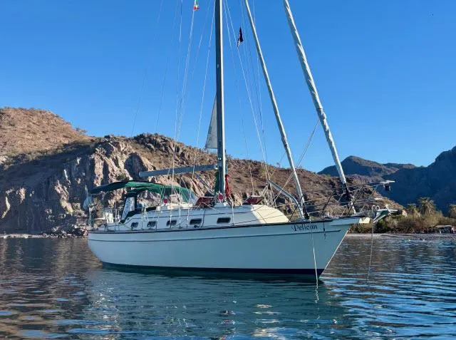 Slide: The Image of 2008 Island Packet 370 sailboat anchored in scenic coastal waters. - 44