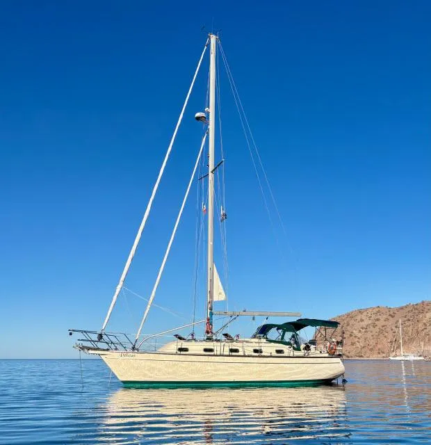 Slide: The Image of 2008 Island Packet 370 sailboat on calm water under clear blue sky. - 45
