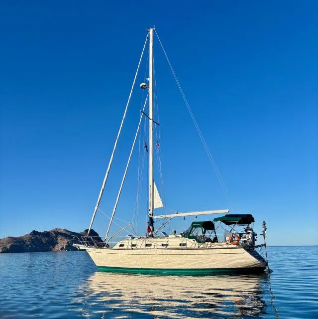 Slide: The Image of 2008 Island Packet 370 sailboat on calm water with clear blue sky. - 46