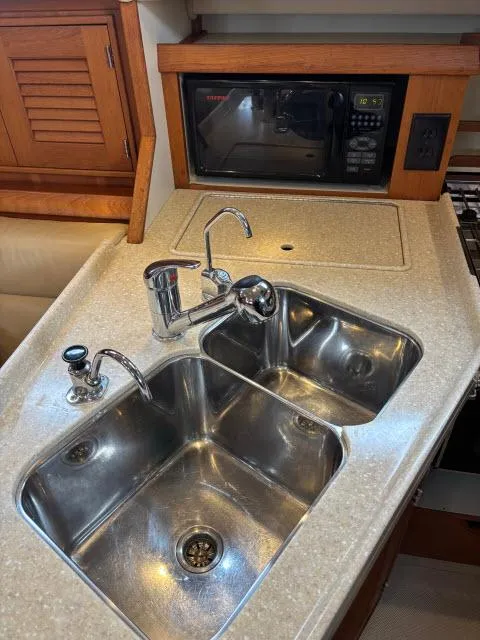 Slide: The Image of 2008 Island Packet 370 yacht kitchen with dual sinks and microwave. - 9