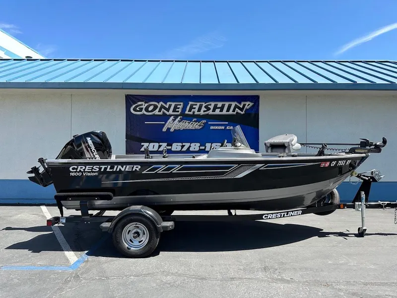Slide: The Image of 2017 Crestliner 1600 Vision boat on trailer, parked outside a fishing store. - 1