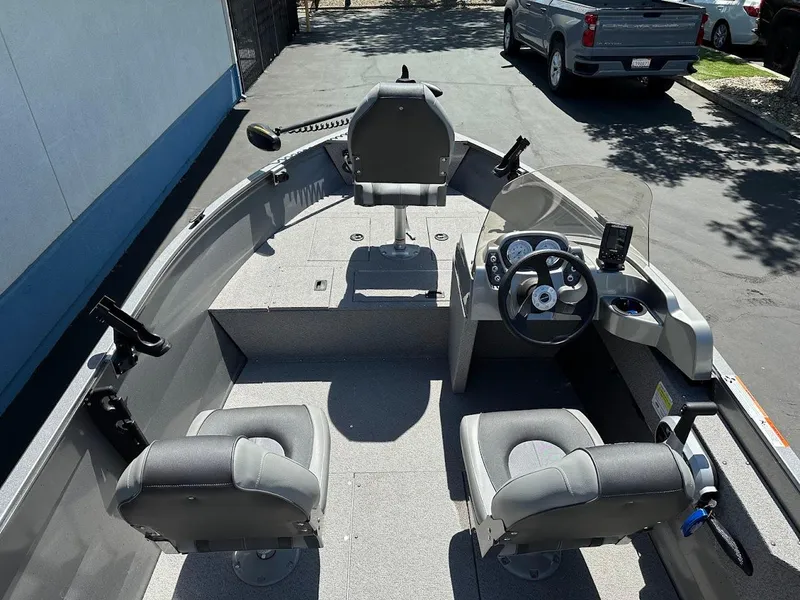Slide: The Image of 2017 Crestliner 1600 Vision boat interior with seating and steering console. - 11