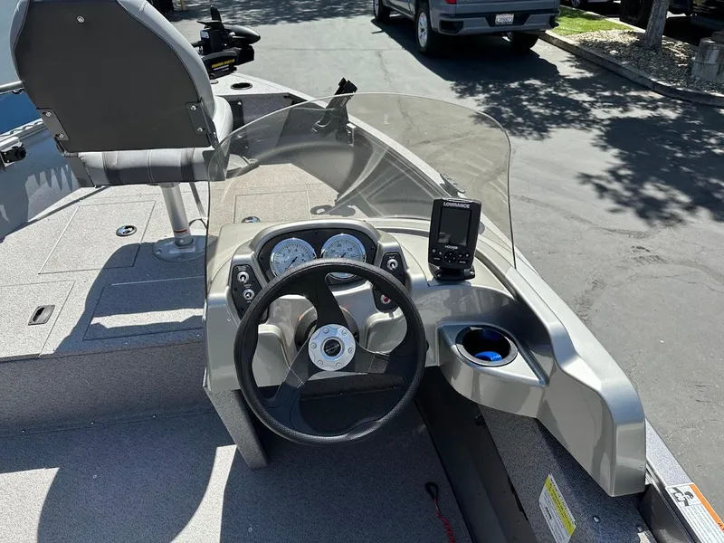 Slide: The Image of 2017 Crestliner 1600 Vision boat dashboard with steering wheel and gauges. - 18