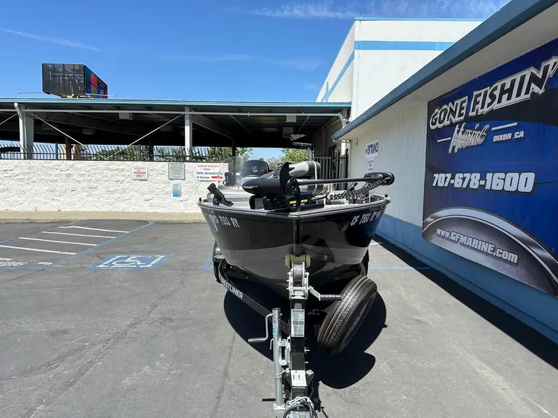 Slide: The Image of 2017 Crestliner 1600 Vision boat on trailer in parking lot, near "Gone Fishin'" sign. - 3