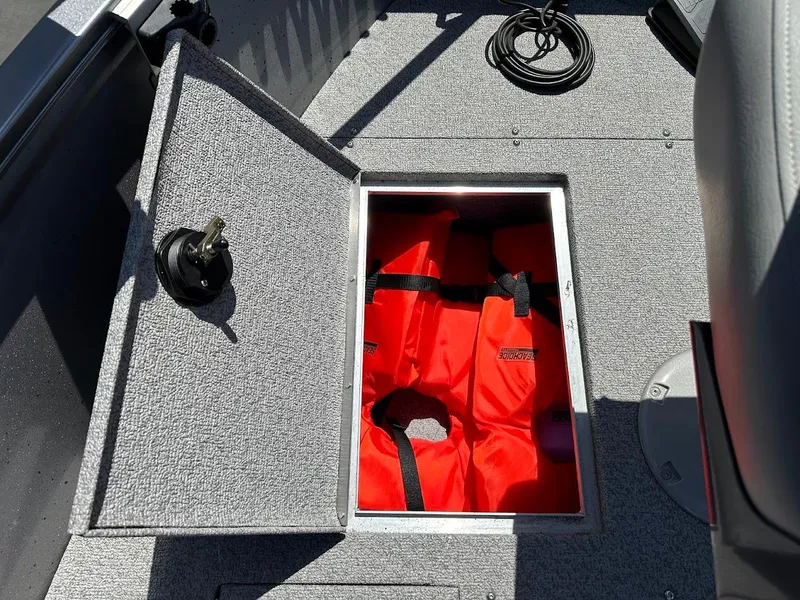 Slide: The Image of 2017 Crestliner 1600 Vision boat storage with red life jackets inside. - 31