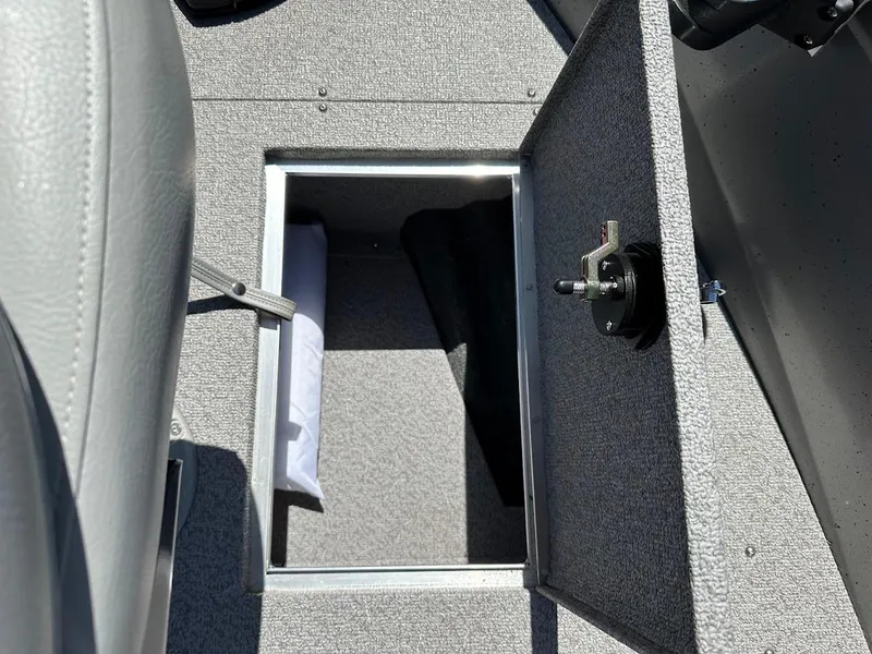 Slide: The Image of 2017 Crestliner 1600 Vision boat storage compartment with open hatch and visible interior. - 32