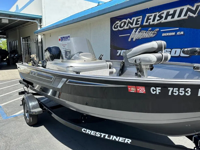 Slide: The Image of 2017 Crestliner 1600 Vision boat on trailer, parked outside a fishing store. - 5
