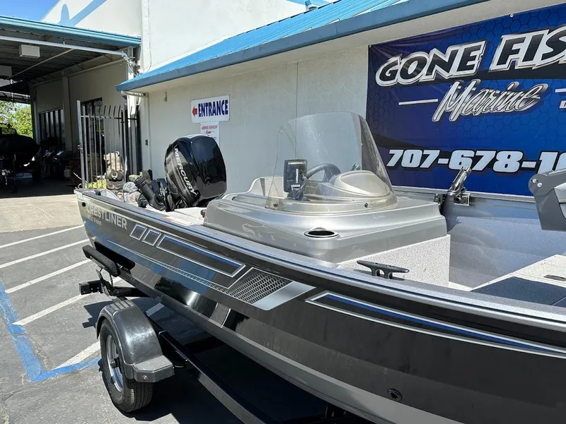 Slide: The Image of 2017 Crestliner 1600 Vision boat parked outside marine shop. - 6