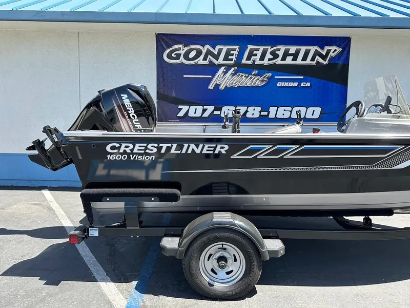 Slide: The Image of 2017 Crestliner 1600 Vision boat on trailer, displayed at dealership with "Gone Fishin'" sign. - 7