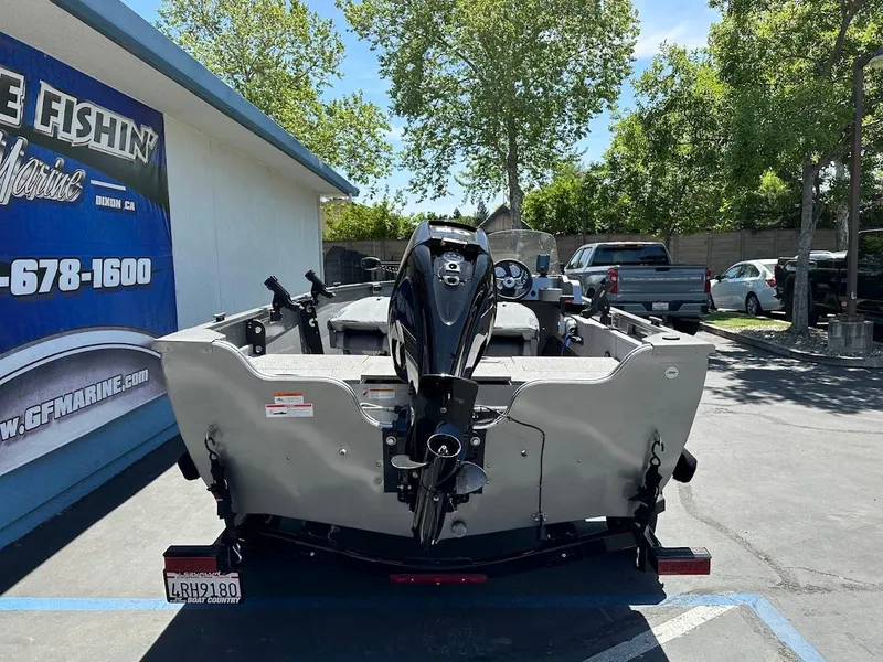 Slide: The Image of 2017 Crestliner 1600 Vision boat with outboard motor, parked outdoors. - 9