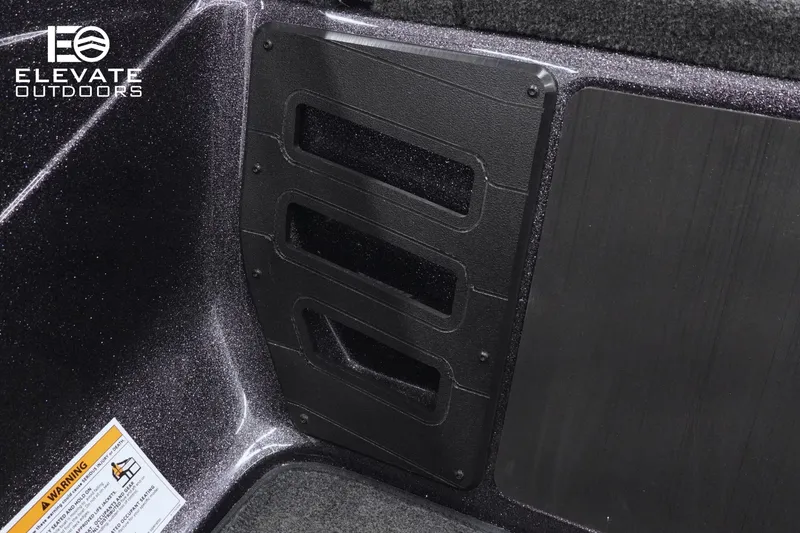 Slide: The Image of Interior detail of 2025 Skeeter ZX150 boat with storage compartment and warning label. - 10