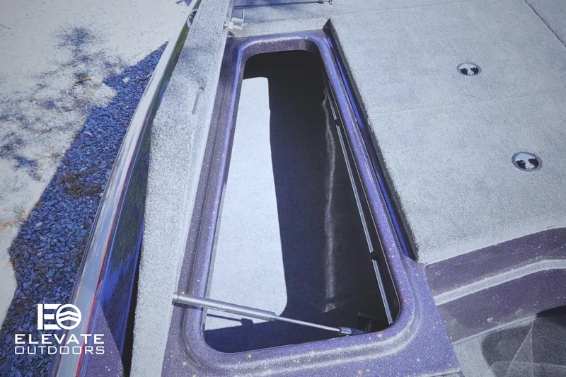 Slide: The Image of 2025 Skeeter ZX150 boat storage compartment with open lid, featuring Elevate Outdoors branding. - 12