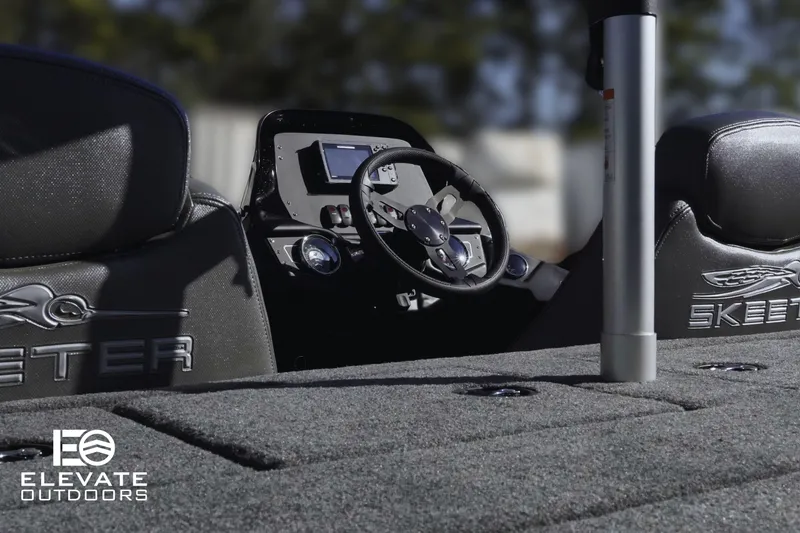 Slide: The Image of 2025 Skeeter ZX150 boat interior with steering wheel and dashboard, featuring Elevate Outdoors branding. - 13