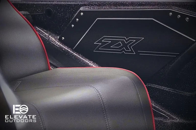 Slide: The Image of 2025 Skeeter ZX150 interior with sleek black and red seating, featuring ZX branding. - 16