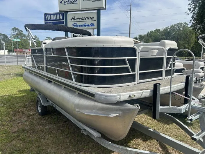 Slide: The Image of 2022 Sweetwater SW 1886 c pontoon boat on trailer, parked outdoors. - 7