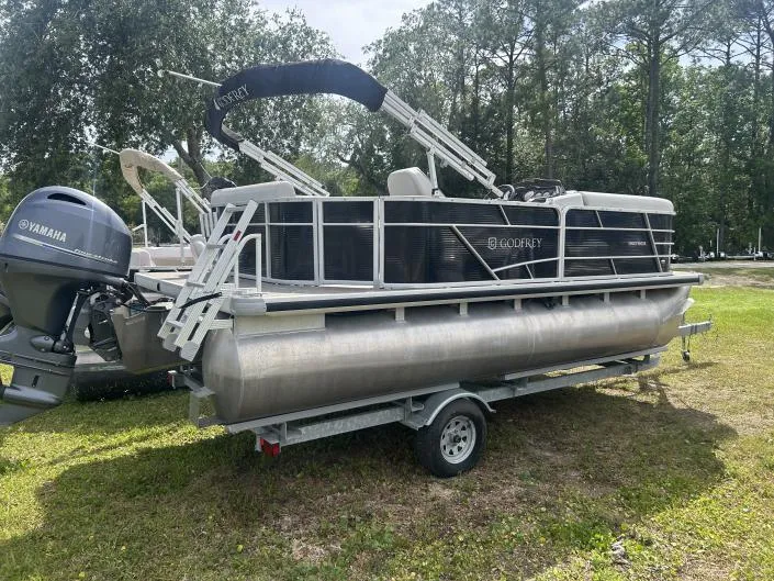 Slide: The Image of 2022 Sweetwater SW 1886 c pontoon boat on trailer, featuring Yamaha outboard motor. - 8