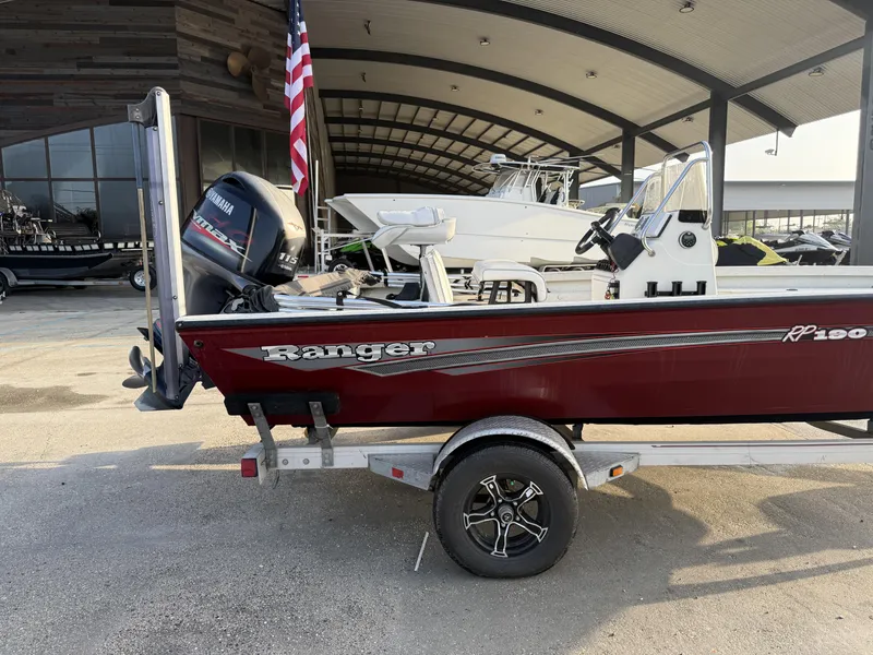 Slide: The Image of 2016 Ranger RP 190 boat with Yamaha motor on trailer, parked near a building. - 10