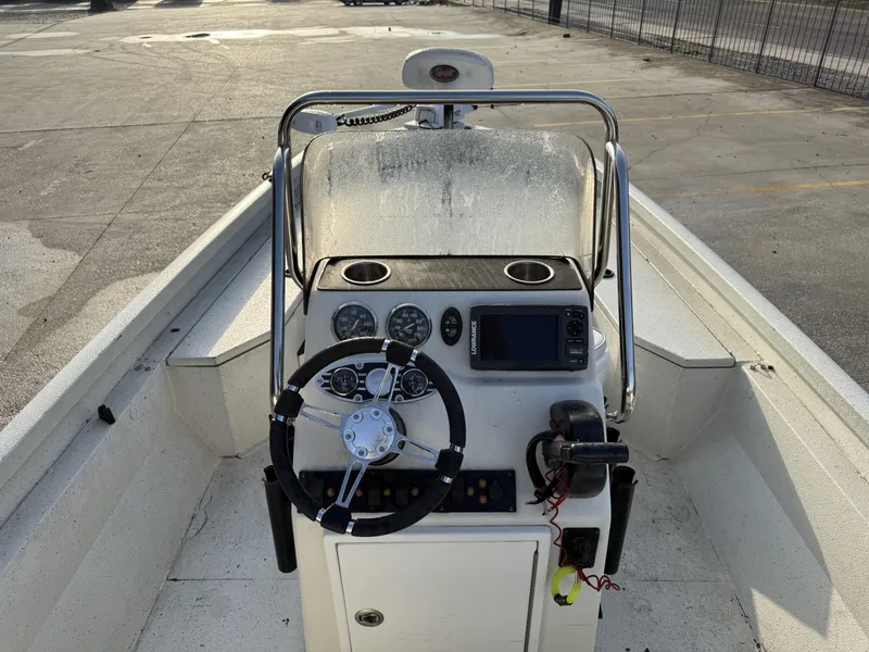 Slide: The Image of 2016 Ranger RP 190 boat console with steering wheel and navigation equipment. - 11