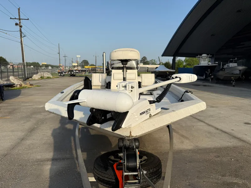 Slide: The Image of 2016 Ranger RP 190 boat with Minn Kota trolling motor, parked outdoors near a showroom. - 5