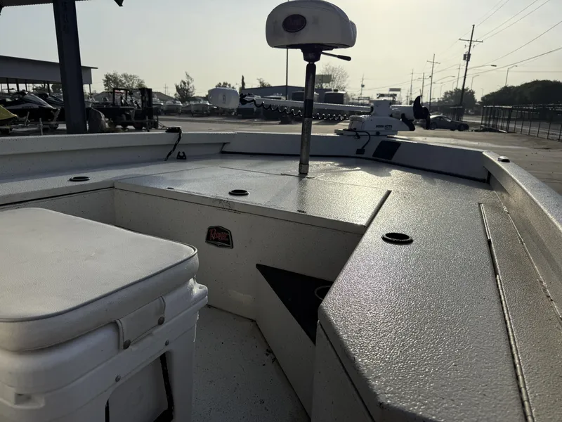 Slide: The Image of 2016 Ranger RP 190 boat interior with seating and storage, parked outdoors. - 6