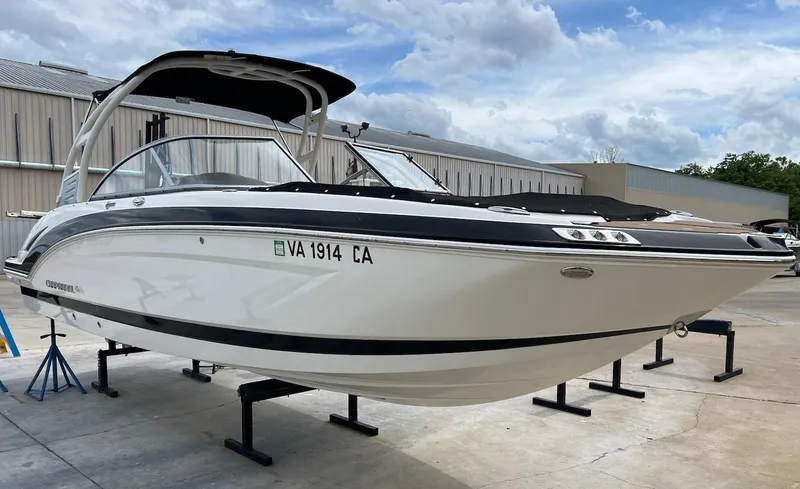 Slide: The Image of 2016 Chaparral 250 Suncoast boat on stands, white hull, outdoor storage. - 0