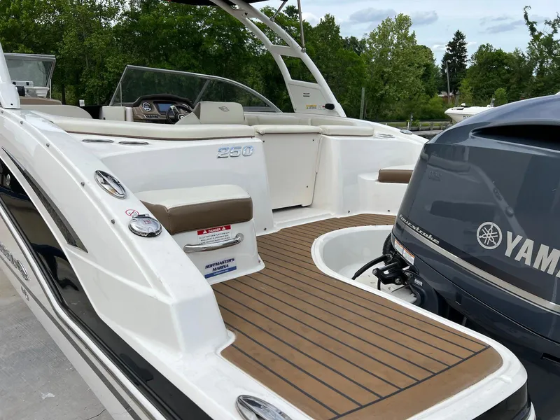 Slide: The Image of 2016 Chaparral 250 Suncoast boat with Yamaha engine, featuring spacious deck and seating. - 17