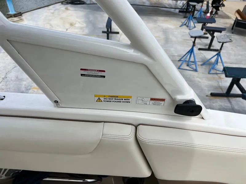 Slide: The Image of 2016 Chaparral 250 Suncoast interior detail with safety warning labels. - 19